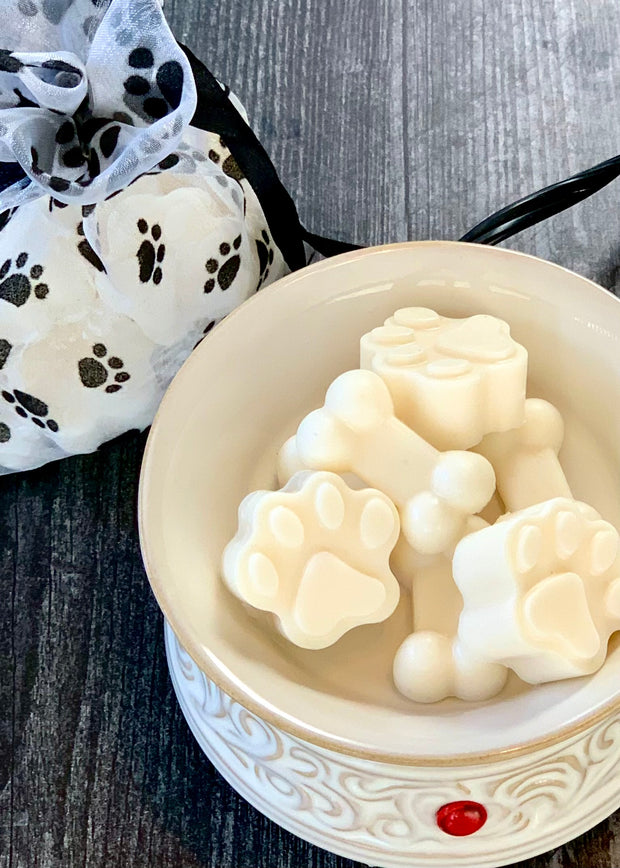 molded wax paw prints and dog biscuits in wax warmer with paw print drawstring gift bag